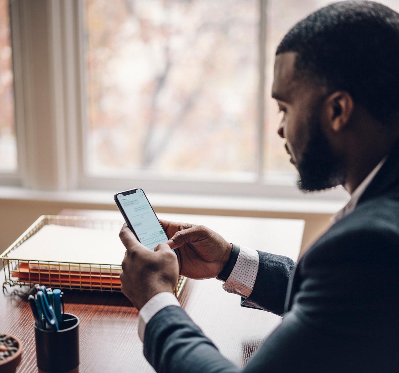 Man texting in office